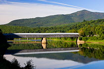 The Windsor-Cornish covered bridge spans the Connecticut River between Windsor, Vermont and Cornish, New Hampshire, USA. Longest covered bridge in the world. Mount Ascutney in the background. August 2...