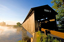 The Mount Orne covered bridge spanning the Connecticut River between Lunenburg, Vermont and Lancaster, New Hampshire, USA. sunrise, August 2007