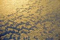 Aerial view of sun reflected off the Myrdalsjokull Glacier, in South Iceland, April 2010