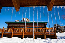 Icicles hanging from roof in winter, Brush Creek Ranch, Saratoga, Wyoming, USA, February 2010