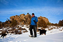 Cross country skier, skiing with two dogs, Brush Creek Ranch, Saratoga, Wyoming, USA, February 2010