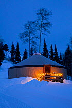 Yurt at night in deep winter snow, Brush Creek Ranch, Saratoga, Wyoming, USA, February 2010