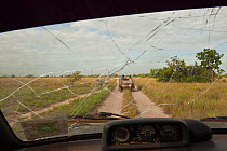 View of the Savannah grasslands through a shattered windscreen, Rupununi, Guyana, March 2010