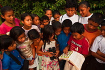 Fairview Amerindian Village children who belong to the Fairview Wildlife Club identifying birds, Iwokrama Forest Reserve,  Guyana, February 2010