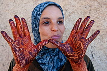 Woman shows her hands decorated with Henna, Djemaa el-Fna (the square), Marrakech, Morocoo