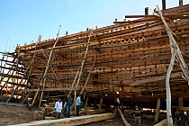 Building a wooden boat (dhow) at Mandvi Port, Gujarat, India, December 2009