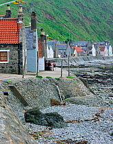 Crovie, a small village on a narrow ledge along the sea made up a single row of houses, Aberdeenshire, Scotland, UK, May 2010