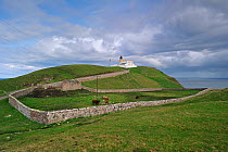 Traditional stone walls and the Stoer Head Lighthouse, Point of Stoer, Sutherland, Highlands, Scotland, UK, May 2010