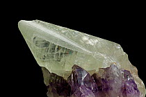 Calcite crystal on Amethyst. Calcite [Ca Co3 / Calcium Carbonate] one of the most common minerals on Earth. Amethyst [Sio2 / Silicon dioxide] a form of Quartz, the most common mineral on Earth