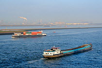 Motor barge and small container ship passing one another near Hook of Holland harbour. Netherlands, April, 2010.