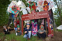 Children with woodland art celebrating anniversary event. Part of Enchanted Woodland Event at Sanquhar Woods (Forres Community Woodland Trust), Scotland, May 2007.
