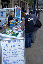 RSPB information stand (Peregrine Watch) set up in Manchester's city centre. England, UK, May 2007.