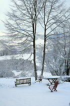 Garden furniture and outlook view towards Box village in winter snow, Wiltshire, UK, December 2010
