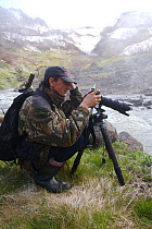 Igor Shpilenok photographing in Valley of the geysers, Kamchatka, Far East Russia, May 2007, photograph by Dmitry Shpilenok