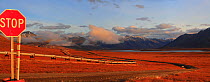 Dalton Highway, famous Alaska Pipeline after crossing Brooks Range with back view to the south to Pump Station N4 (on the hill). Galbrath lake at right. The mountainous tundra of Alaska.  North Americ...