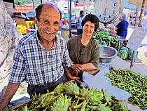 People selling fresh and local produce at the vegetable market at Hania, Crete island, Greece