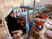Portrait of woman working at weaving and needlework, Anogia village. Crete, Greece.
