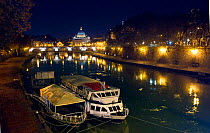 The river Tiber at night with St Peter's cathedral, Vatican,  background. Rome, Italy, December 2009
