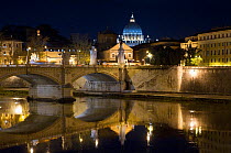 Bridge over the river Tiber at night with St Peter's cathedral, Vatican,  background. Rome, Italy, December