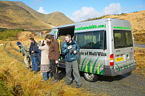 Tourists departing for a wildlife spotting trip on the Isle of Mull. Inner Hebrides, Scotland, April.