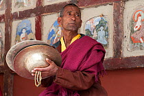 Elderly Buddhist monk, during rehearsal for festival at Hemis Gompa, Ladakh, India, June 2010
