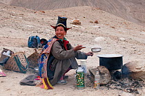 Ladakhi woman cooking on a camp fire, Phyang, Kardung village, Ladakh, India, June 2010