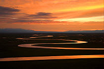 Sunset over winding river in Bayinbuluke Swan Lake Nature Reserve. Xinjiang, China. Picture taken during filming of BBC "Wild China" TV Series, June 2006.