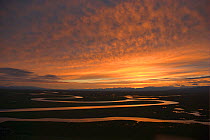 Sunset over winding river in Bayinbuluke Swan Lake Nature Reserve, Xinjiang, China. Picture taken during filming of BBC "Wild China" TV Series, June 2006.