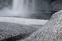 Ice-covered surfaces around the Seljalandsfoss waterfall after a cold night, Iceland, April 2010