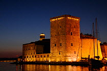 17th Century Fort St. Jean at the entrance to Marseille harbour, illuminated at night. France, May 2010.