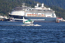 Sightseeing seaplane landing in front of docked cruise ship, Ketchikan, Alaska, USA, September 2010