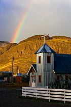 Rainbow above church in the village of El Chalten, Los Glaciares National Park, Patagonia, Argentina, January 2006