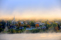 Early morning mist and autumn colours in Grande Piles Village and St Maurice river. Quebec, Canada, October 2010