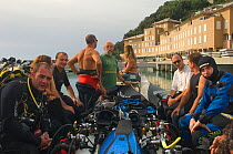 Group of divers on dive boat visiting wreck of crude oil super-tanker "Amoco Milford Haven", which sank on April 14th, 1991 after three days of fire. Genoa, Italy, August 2007.