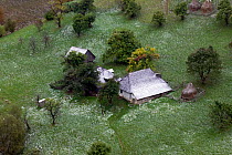 Traditional small holding with orchard, part of a peasant economy, in first snow. Romania, October 2010