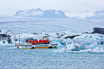Tourist boat by icebergs in Jokulsarlon Lagoon, Vatnajokull Glacier, Iceland, July 2009