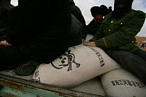 Sacks of poison distributed to farmers as part of an annual compulsory cull to control the Tibetan Pika (Ochotona thibetana) population, Qinghai Province, Tibet, China. December 2006.