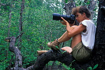 Photographer, Catherine Jouan, photographing in mangrove swamp, Bako NP, Borneo, Sarawak, Malaysia. Model released
