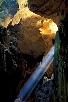 Shaft of light shining through Niah cave, interior, Niah NP, Borneo, Sarawak, Malaysia