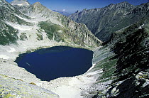 Glacial Black Murudzhinskoe Lake in rocky cirque, Teberdinskiy Nature Reserve, Western Caucasus, Russia