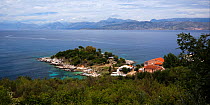 View from the top of the old castle at Kassiopi over the water to Albania, north-east Corfu, Greece, June 2010.