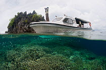 Rangers on their patrol boat patrolling the protected waters. Misool, Raja Ampat, West Papua, Indonesia, January 2010.