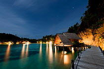 Bungalows of Misool Eco Resort as night falls. Misool, Raja Ampat, West Papua, Indonesia, January 2010.