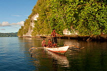 West Papuan fishermen spearfishing in their outrigger boat. Raja Ampat, West Papua, Indonesia, February 2010.