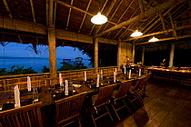Sorido Bay Resort dining room with the table laid for a meal. Raja Ampat, West Papua, Indonesia, February 2010.