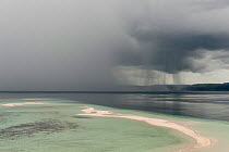 Sand cay and approaching rainstorm over the sea. Raja Ampat, West Papua, Indonesia, February 2010