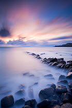 Kimmeridge Bay at sunset, with mist over rocks and the sea. Dorset, UK, October 2010