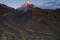 Southern slope of Mount Kazbek / Mkinvartsveri and the gorge of Gergeti glacier in the Khokh range at sunrise. Greater Caucasus, Georgia, September 2010