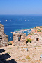 Molyvos / Mithymna harbour, viewed from a tower of the 13th century castle above the town, with sailing yachts gathering for the Aegean regatta offshore. Lesbos / Lesvos, Greece, August 2010