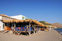 Tavernas on wooden stilts on the beach at Skala Eressos. Lesbos / Lesvos, Greece, August 2010.
